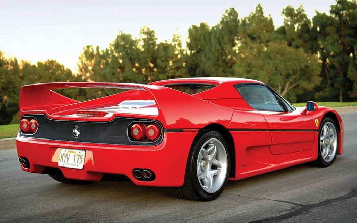 Red Ferrari F50 sports car on a road