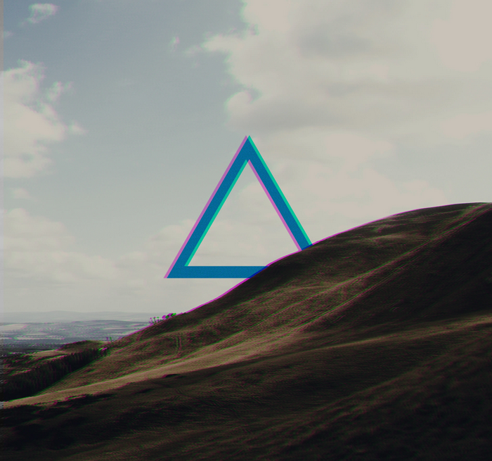 Triangle shape over a grassy hill and sky