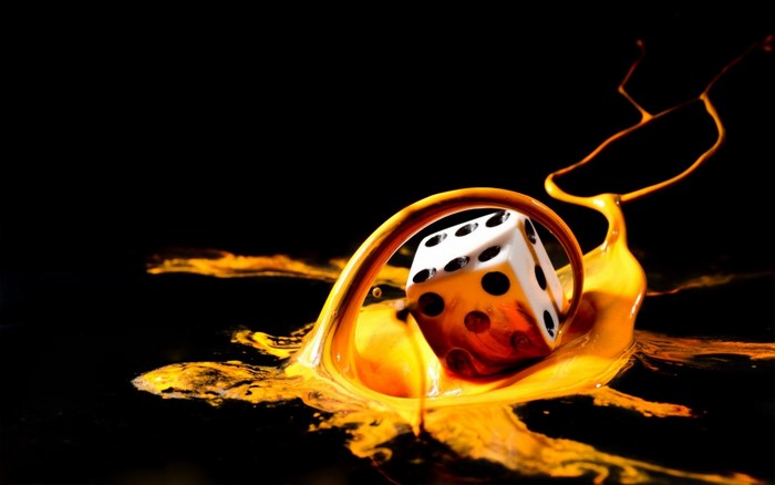 Dice splashing in yellow liquid