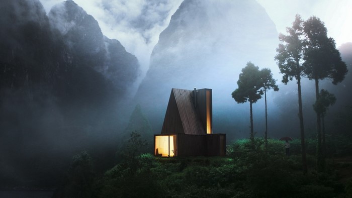 Modern cabin in misty mountains at dawn
