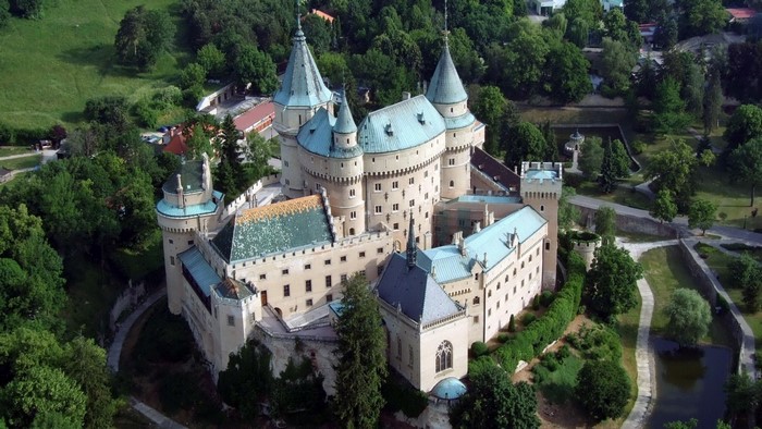 Bojnice Castle Surrounded by Lush Greenery and Trees