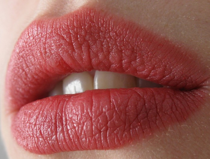 Close-up of woman's red lips with lipstick