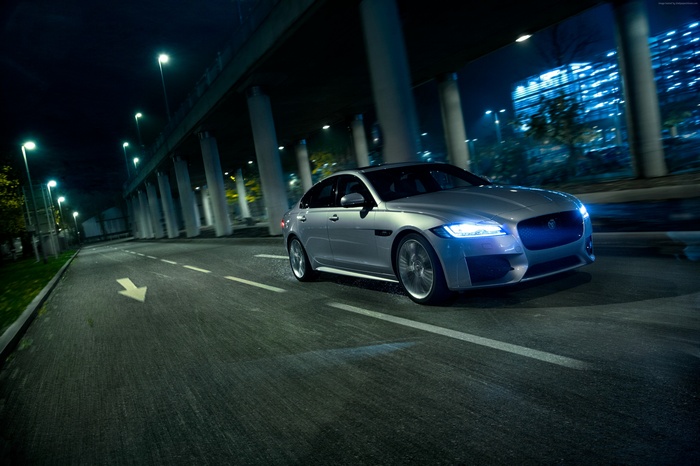 Silver Jaguar XF R-Sport driving at night
