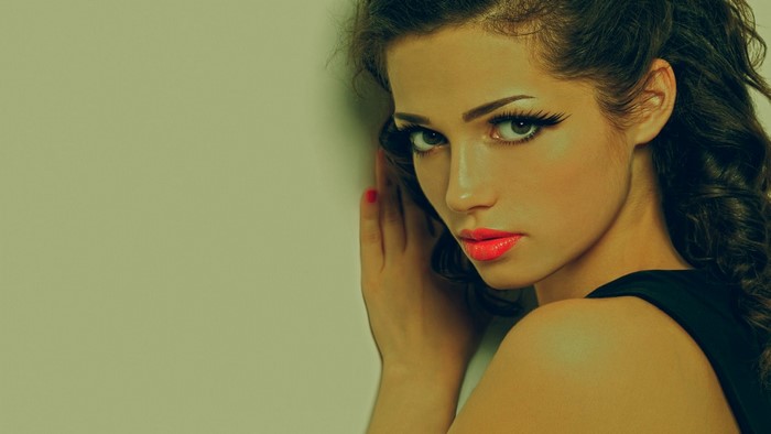 Woman with bright pink lipstick and dark hair