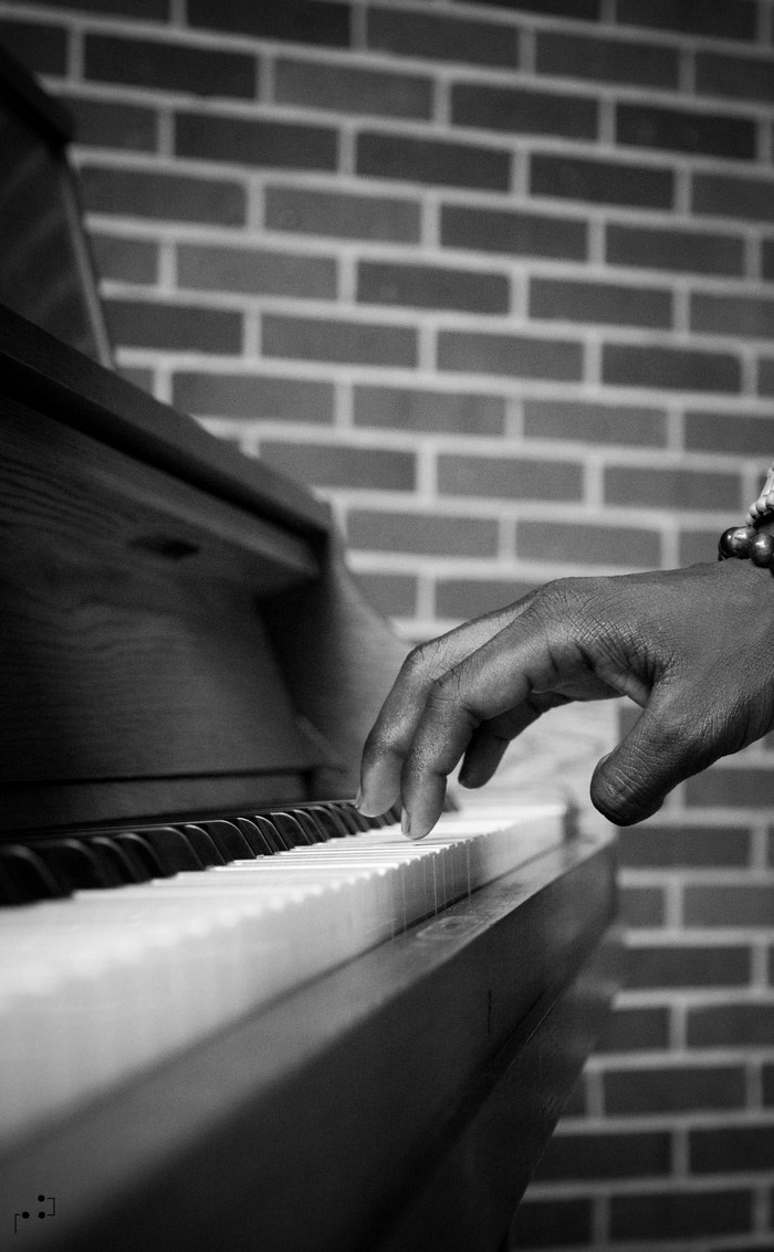 Close-up of a hand playing a piano