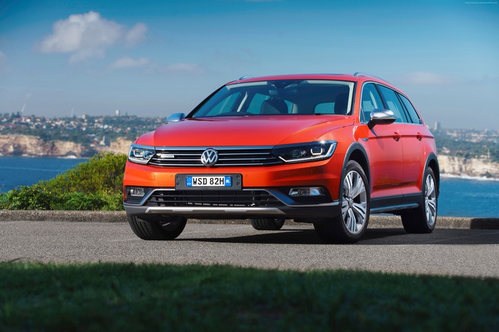 Orange Volkswagen Passat Alltrack parked by the sea