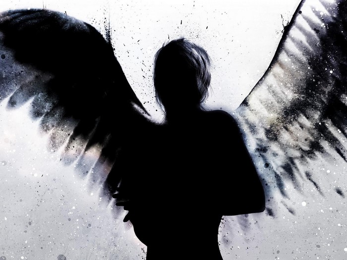 Silhouette of an angel with black wings