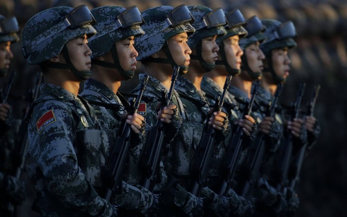 Soldiers in formation holding rifles