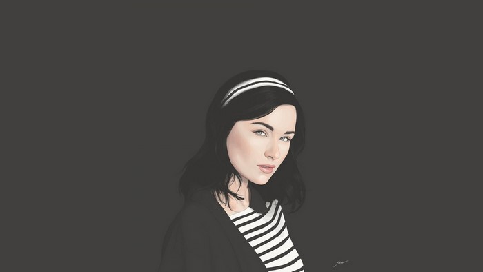 Woman with black hair and headband wearing striped shirt and jacket
