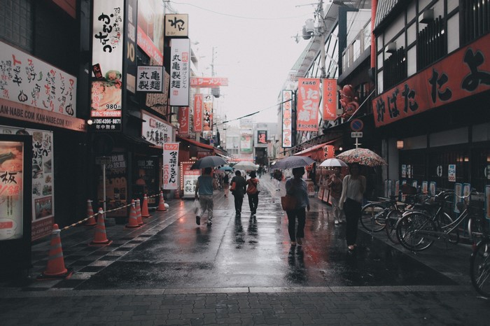 Street scene in Japan with people holding umbrellas