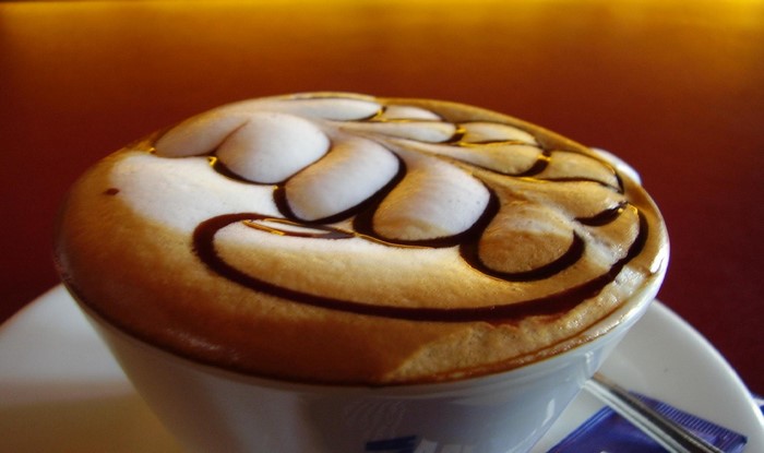 Cappuccino with chocolate art in a white cup