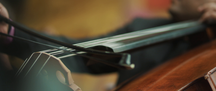 Close up of a person playing a cello