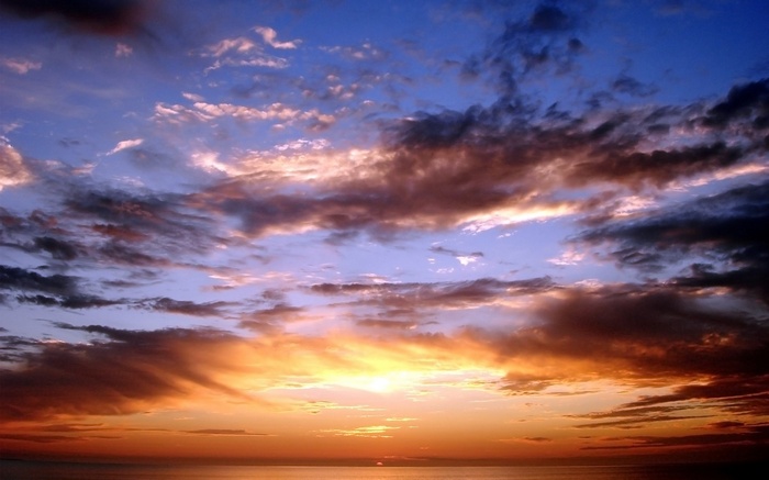 Sunset over the ocean with dramatic clouds