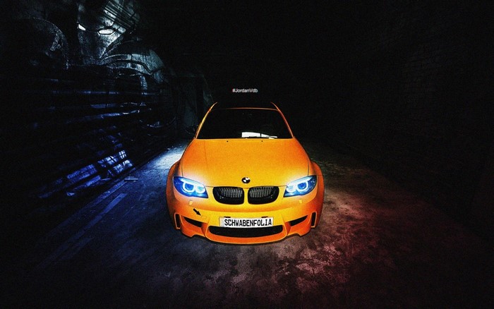 Orange BMW in a dark tunnel with Iron Man helmet