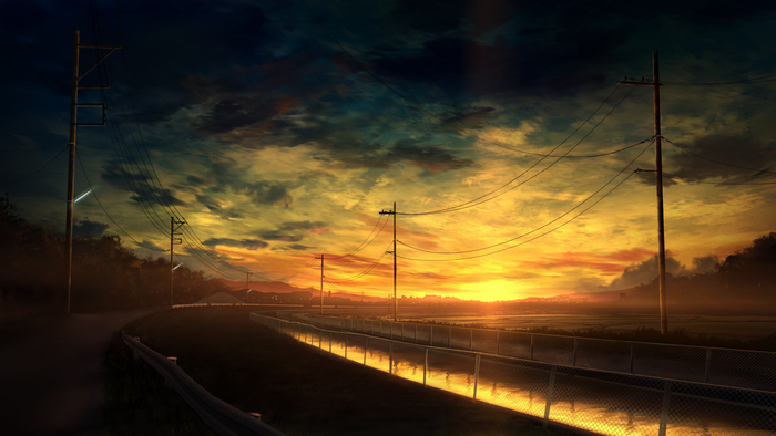 Roadside canal with power lines at sunset