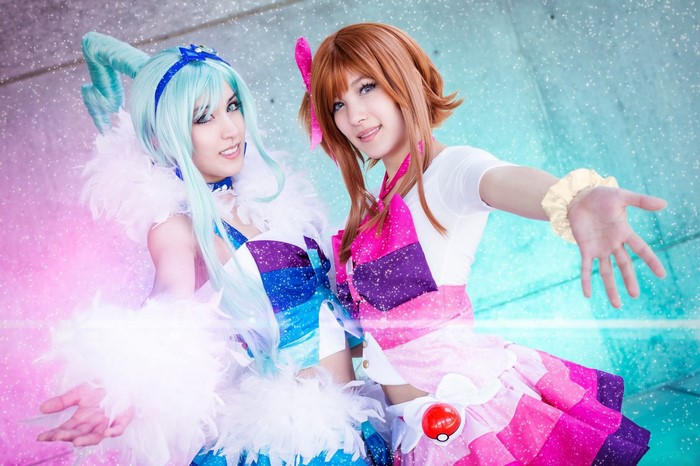 Two women in colorful Pokemon cosplay costumes