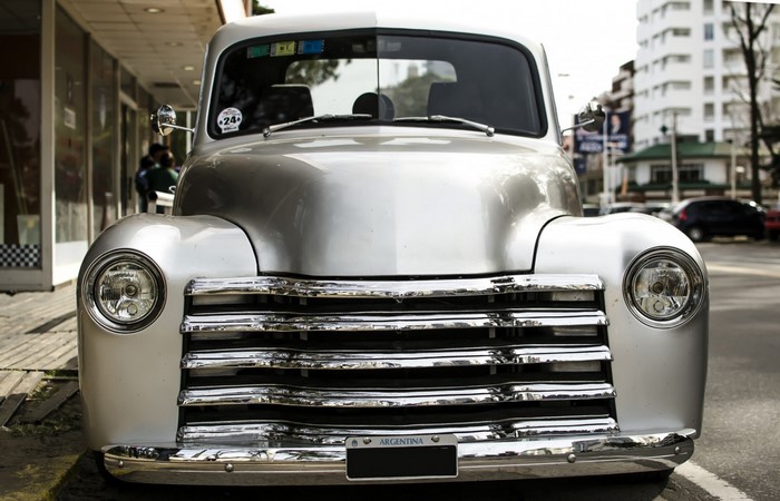 Silver vintage pickup truck with chrome grille