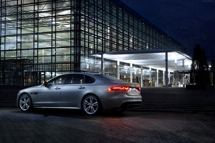 Jaguar XF R-Sport parked outside a modern building at night