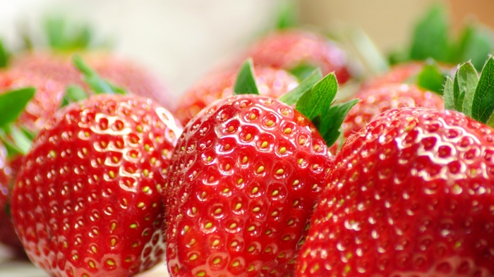 Close-up of fresh strawberries with green leaves