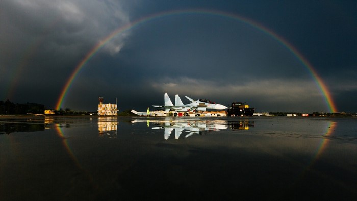 Sukhoi Su-27 fighter jet under a rainbow