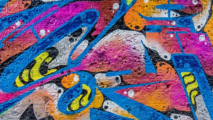Colorful abstract graffiti art on a brick wall