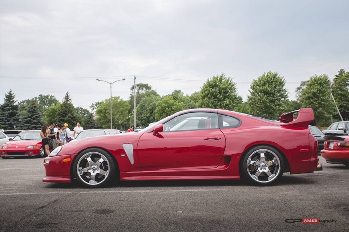 Red Toyota Supra parked at car show