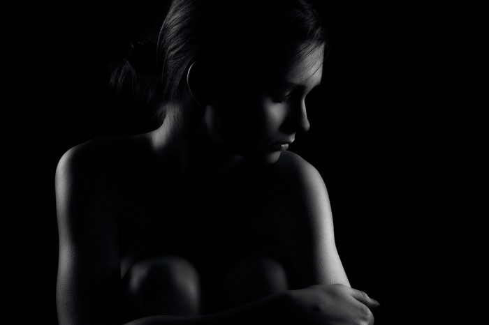 Monochrome portrait of a woman in darkness
