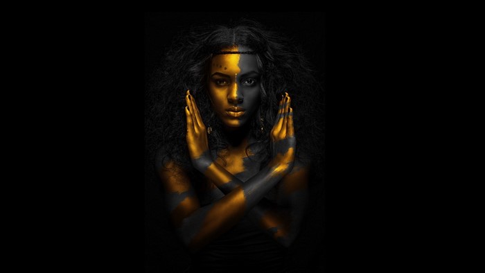 Woman with gold and black body paint
