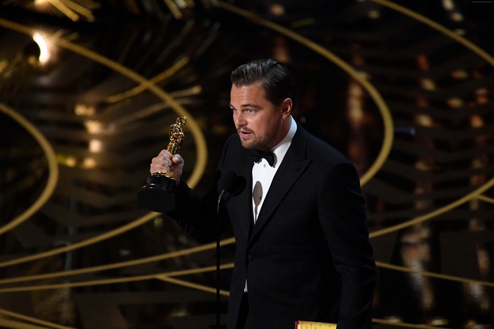 Leonardo DiCaprio holding an Oscar award