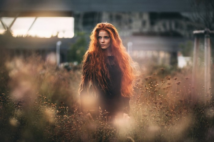 Redhead Woman in Autumn Field with Sunlight