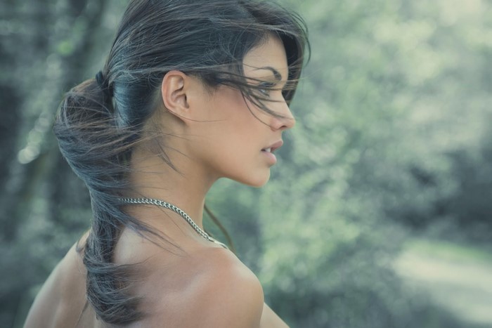 Woman with dark hair in a ponytail, profile view