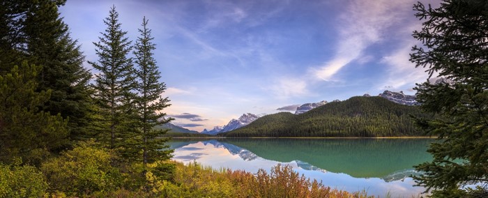 Lake reflection of mountains and trees in Canada