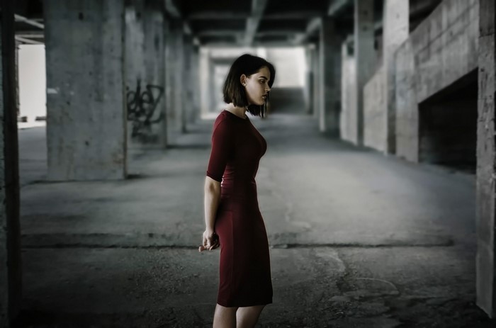 Woman in red dress in abandoned building