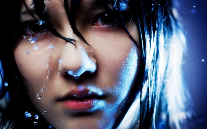 Close up portrait of a woman with water droplets