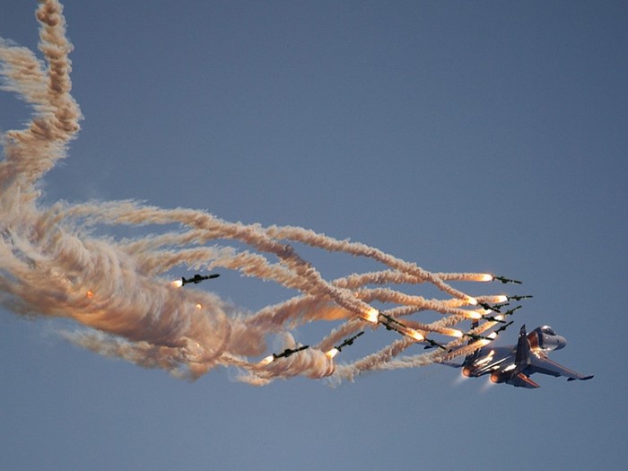 Fighter jet deploying flares during air show