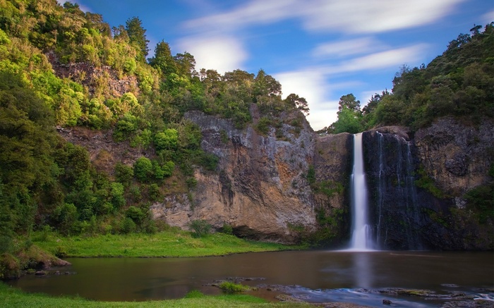 Waterfall cascading down a rocky cliff into a pool