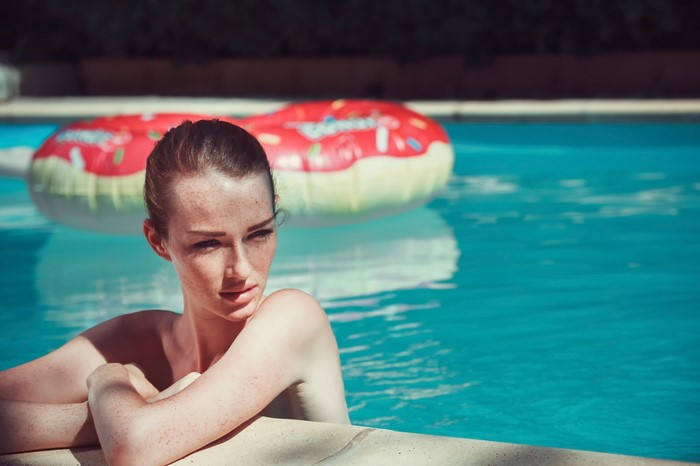 Woman in swimming pool with inflatable donut