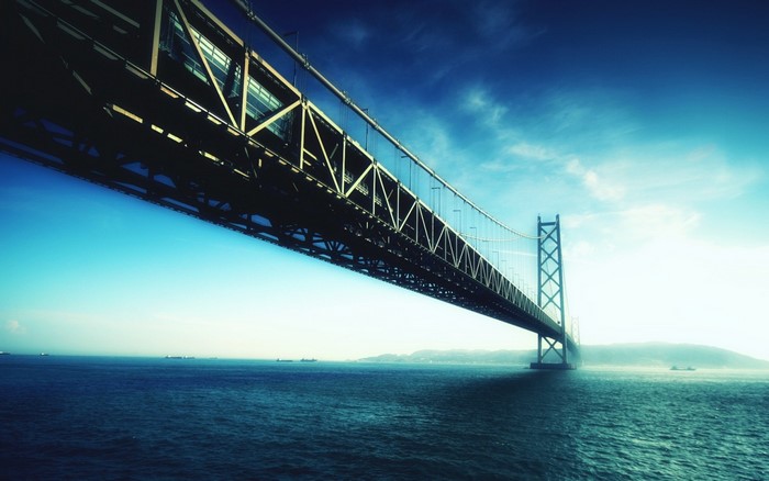 Suspension bridge over the sea at dusk