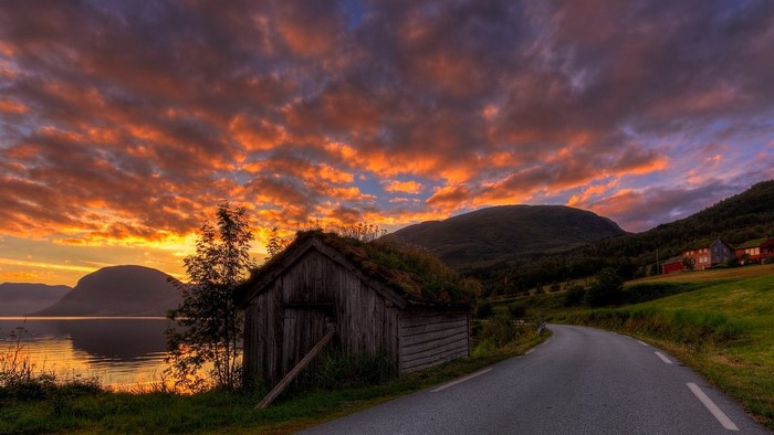 Sunset over a Norwegian Fjord with a Rustic Hut
