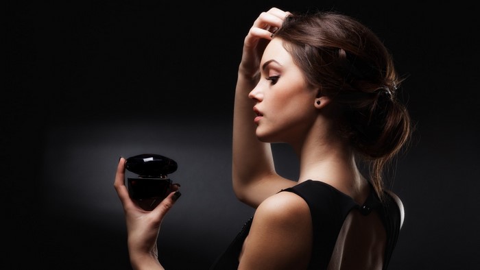 Woman holding a perfume bottle