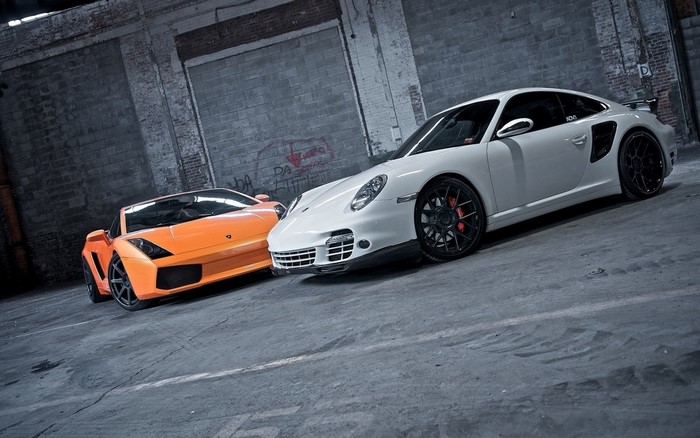 Orange Lamborghini and white Porsche 911 Turbo S