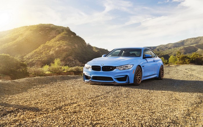 Blue BMW M4 Coupe on Gravel Road with Mountains