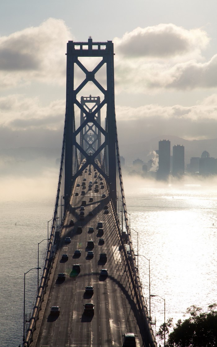 Bay Bridge traffic in San Francisco with fog and city skyline