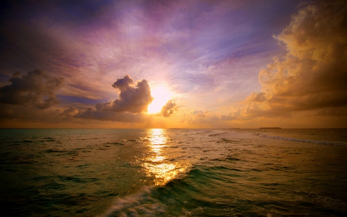 Sunset over the ocean with colorful clouds