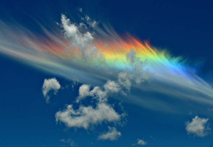 Rainbow and clouds in a blue sky