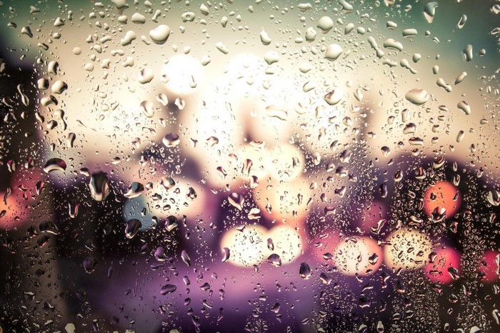 Water droplets on glass with bokeh lights