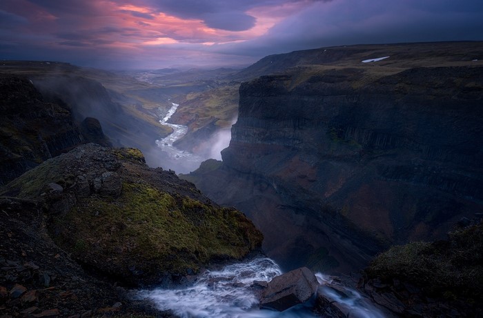 Canyon river valley at sunset with dramatic clouds