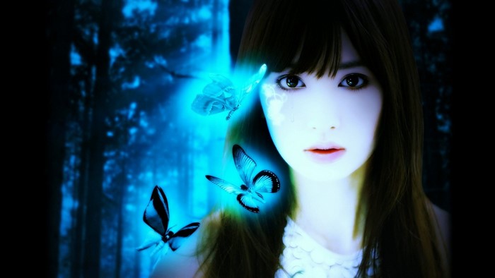 Girl with blue butterflies in dark forest