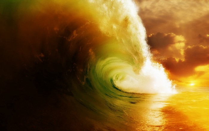 Dramatic wave crashing at sunset with golden light