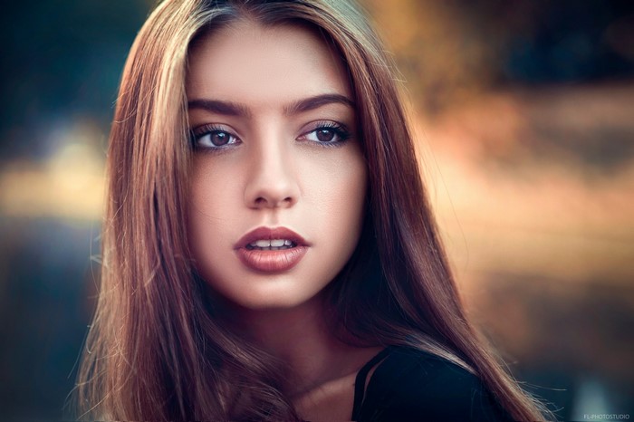 Portrait of a young woman with long brown hair